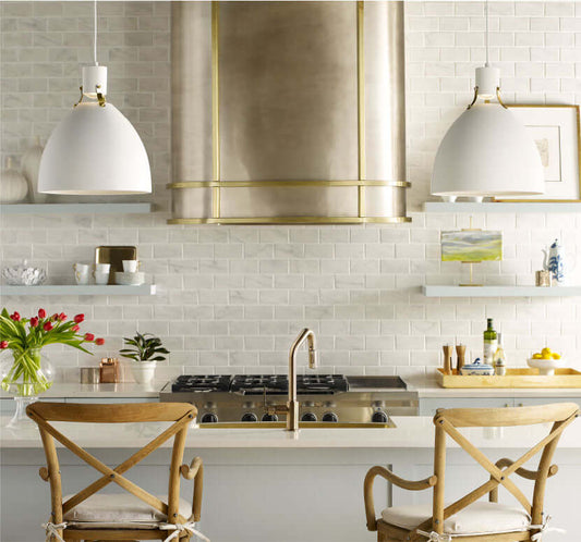 Thompson Quintana Handcrafted Oval Range Hood in Satin Brass and Burnished Nickel - KCRH48 over a modern kitchen island.
