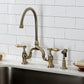 Kingston KS7793BALBS Heirloom Bridge Kitchen Faucet with Brass Sprayer, Antique Brass mounted on a white tiled kitchen wall.