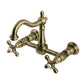 Kingston KS1263AX Heritage Two-Handle Wall Mount Bridge Kitchen Faucet, Antique Brass featuring elegant design and sturdy construction.