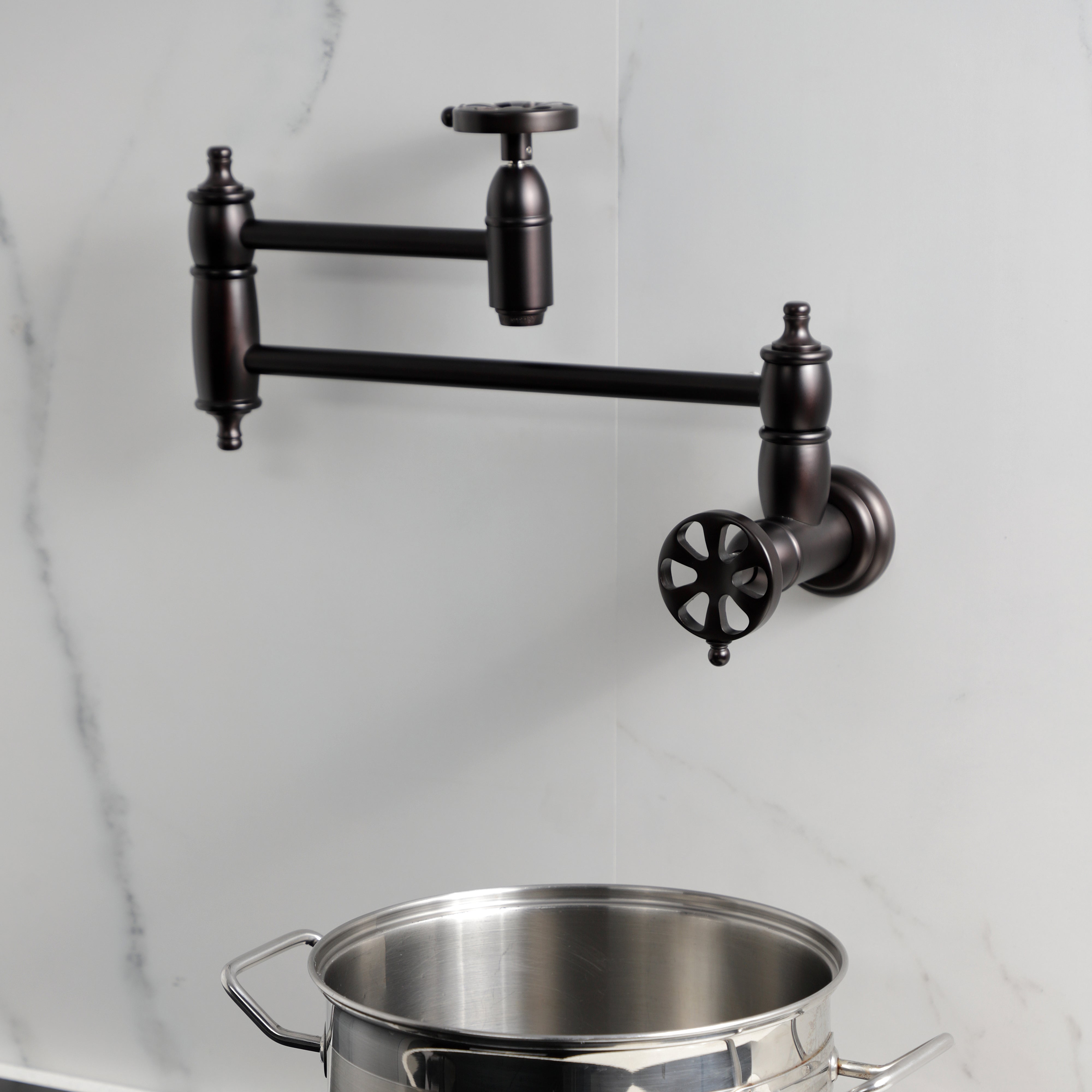 Kingston Brass KS3103RX Belknap Wall Mount Pot Filler Faucet, Antique Brass wall-mounted faucet with pot.