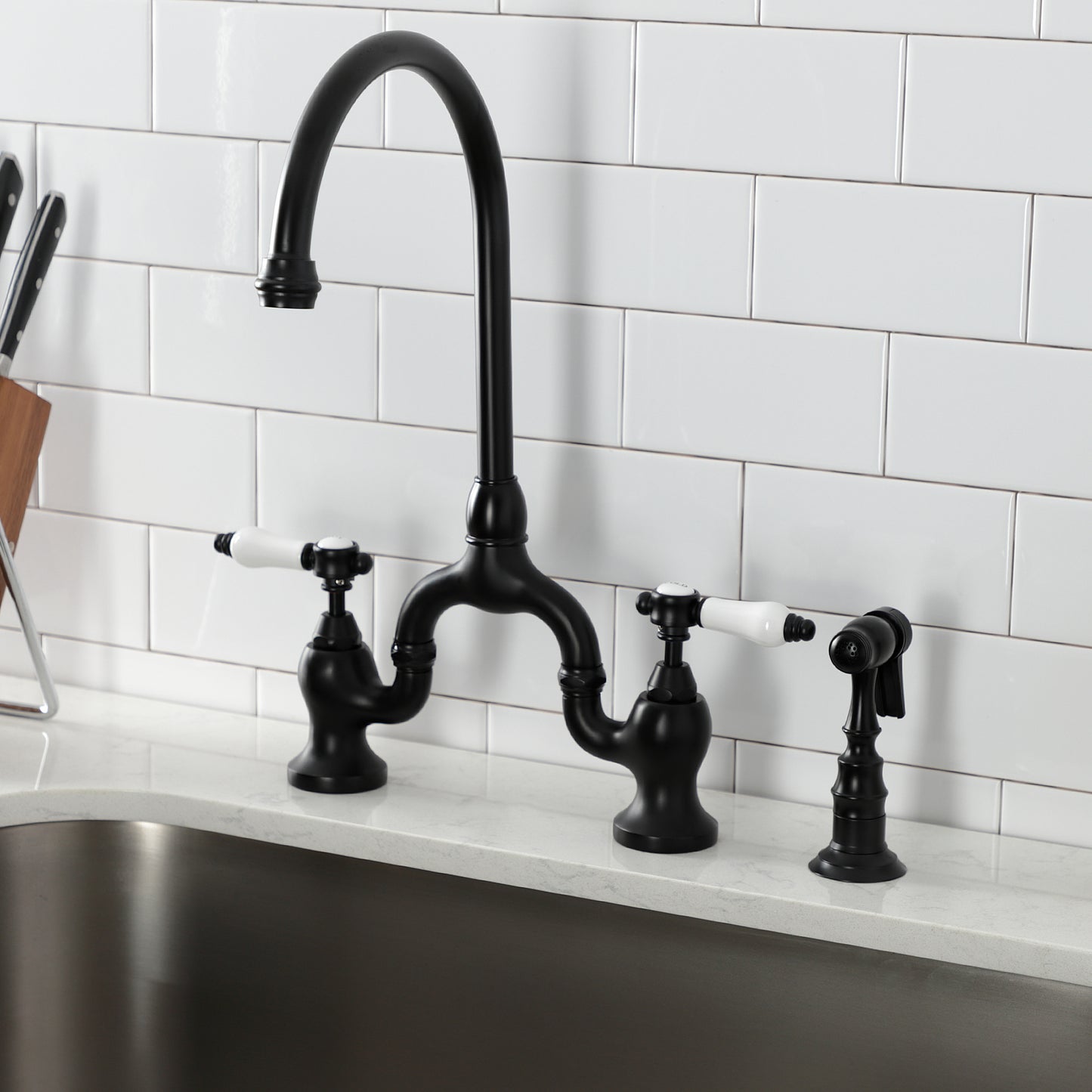 Kingston KS7793BPLBS Bel-Air Bridge Kitchen Faucet with Brass Sprayer, Antique Brass in modern kitchen setting.