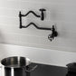 Kingston Brass KS2107RKX Webb Wall Mount Pot Filler Faucet with Knurled Handle, Brushed Brass installed above a pot