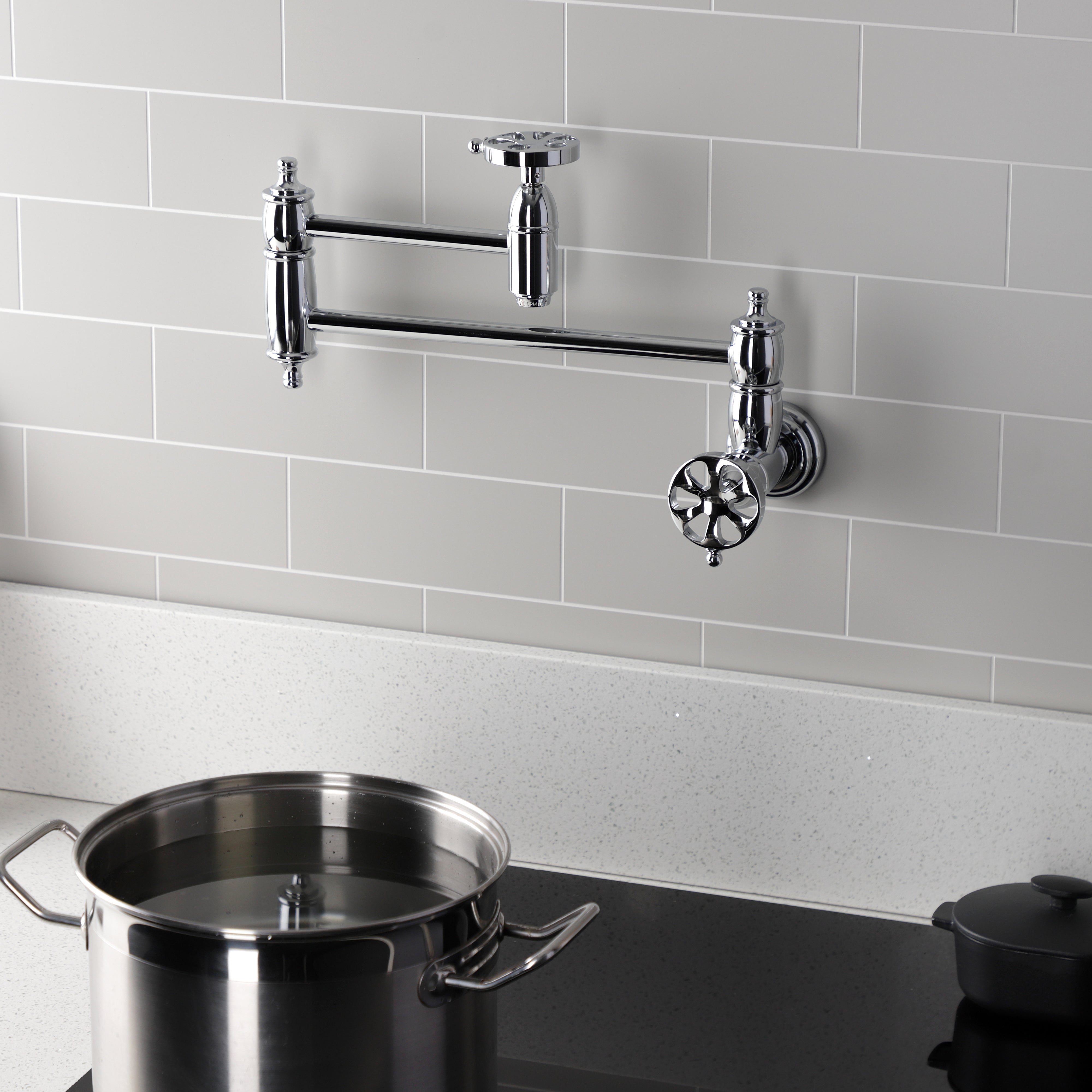 Kingston Brass KS3103RX Belknap Wall Mount Pot Filler Faucet, Antique Brass mounted over a pot on the stove.