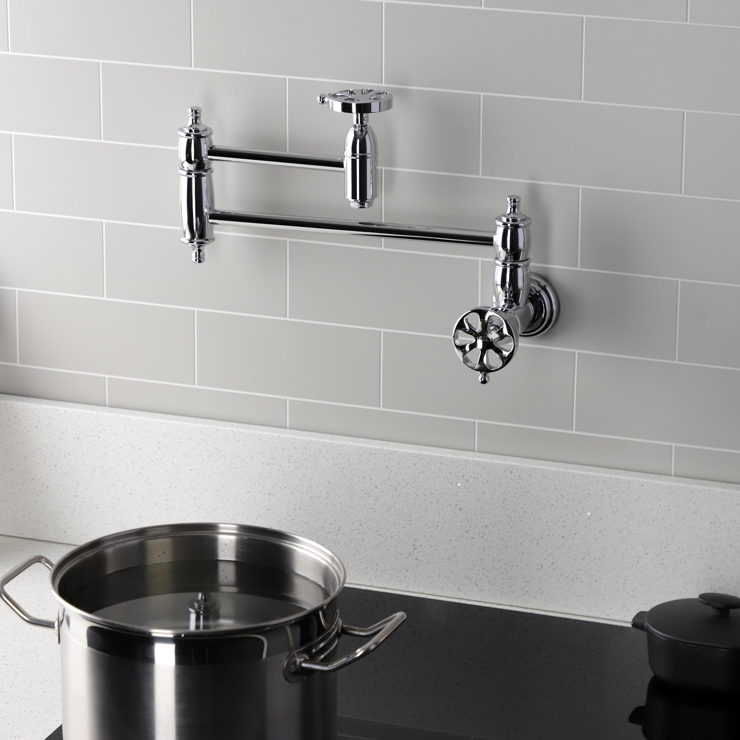 Kingston Brass KS3103RX Belknap Wall Mount Pot Filler Faucet, Antique Brass mounted over a pot on the stove.