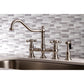 Kingston KS3277AXBS Restoration Bridge Kitchen Faucet with Brass Sprayer, Brushed Brass in traditional kitchen setting.