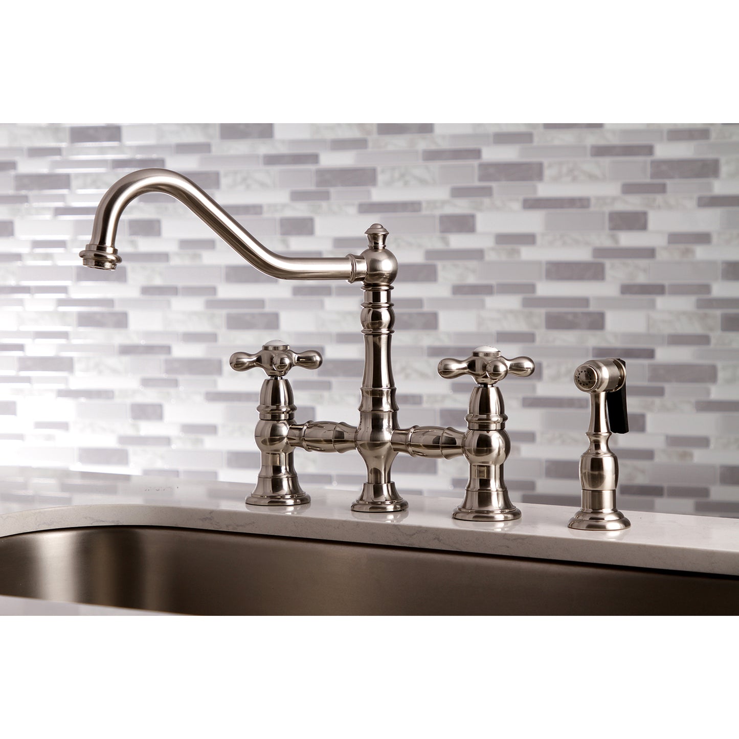 Kingston KS3277AXBS Restoration Bridge Kitchen Faucet with Brass Sprayer, Brushed Brass in traditional kitchen setting.