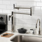 Kingston Brass KS4703CKL Kaiser Deck Mount Pot Filler Faucet, Antique Brass in a modern kitchen setting.