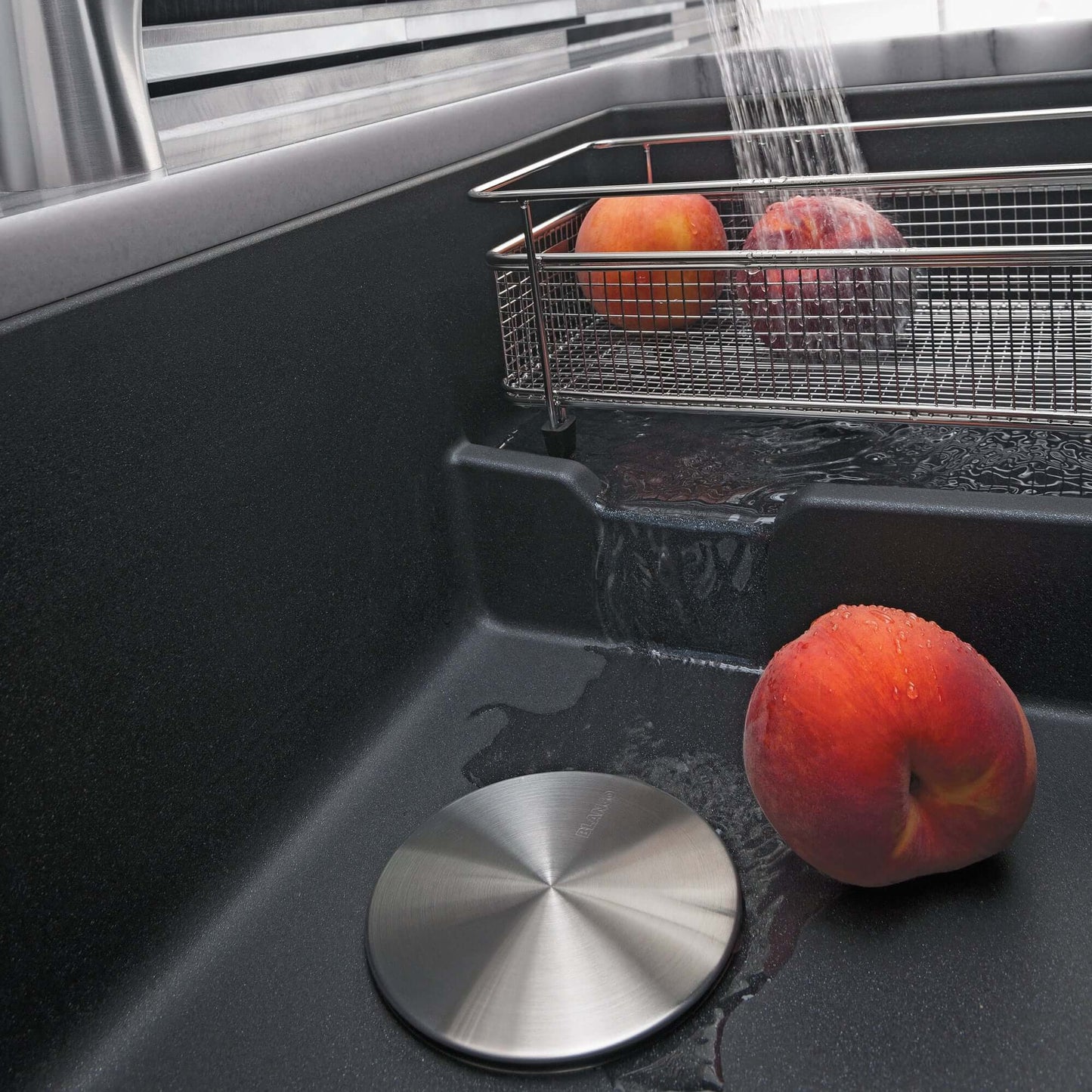 BLANCO Precis Cascade SILGRANIT 29" Single Bowl Undermount Kitchen Sink with Colander displaying washing fruits.