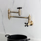 Kingston Brass KS3103PKX Duchess Wall Mount Pot Filler Faucet, Antique Brass in kitchen above pot