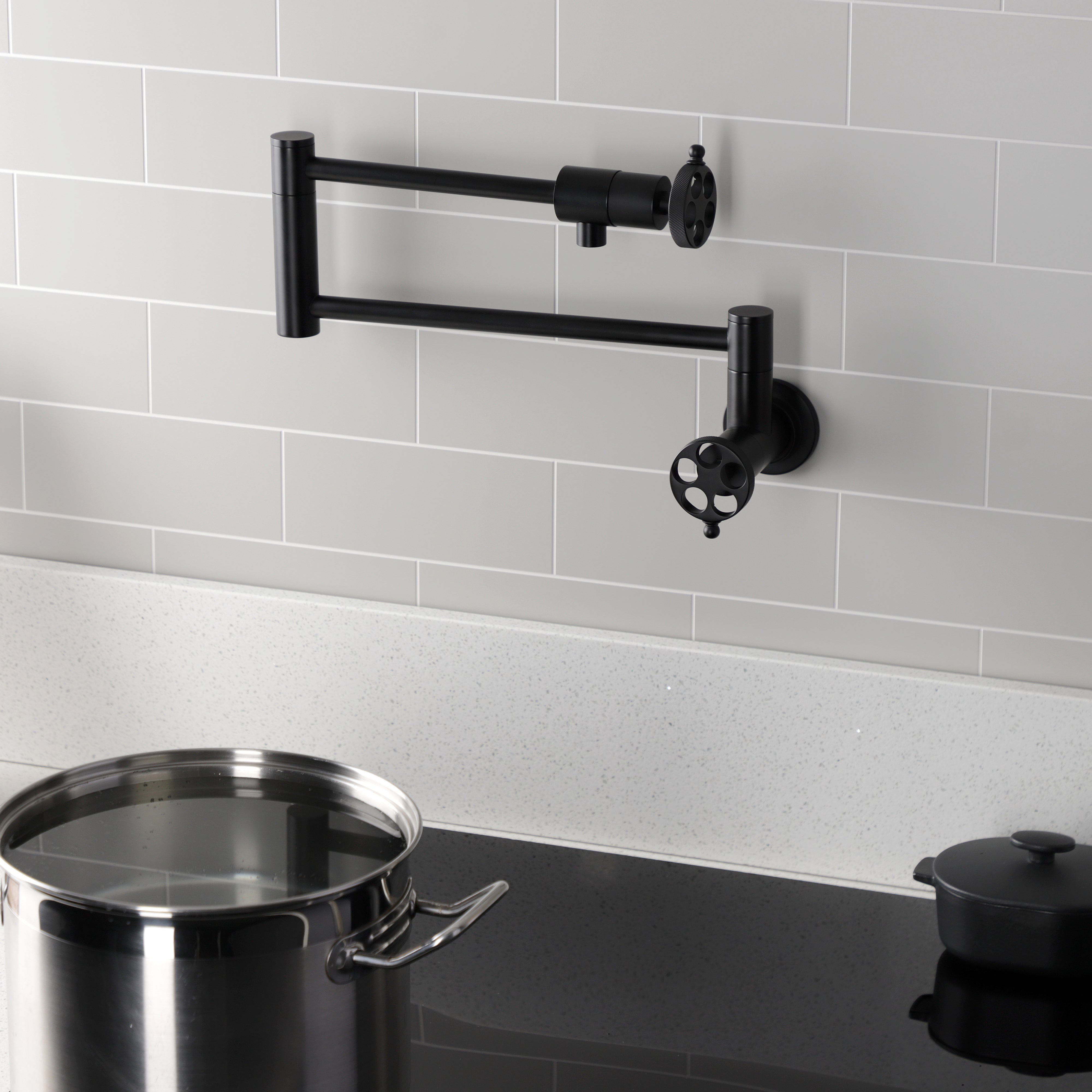 Kingston Brass KS4103RKZ Wendell Wall Mount Pot Filler Faucet with Knurled Handle, Antique Brass in black finish.