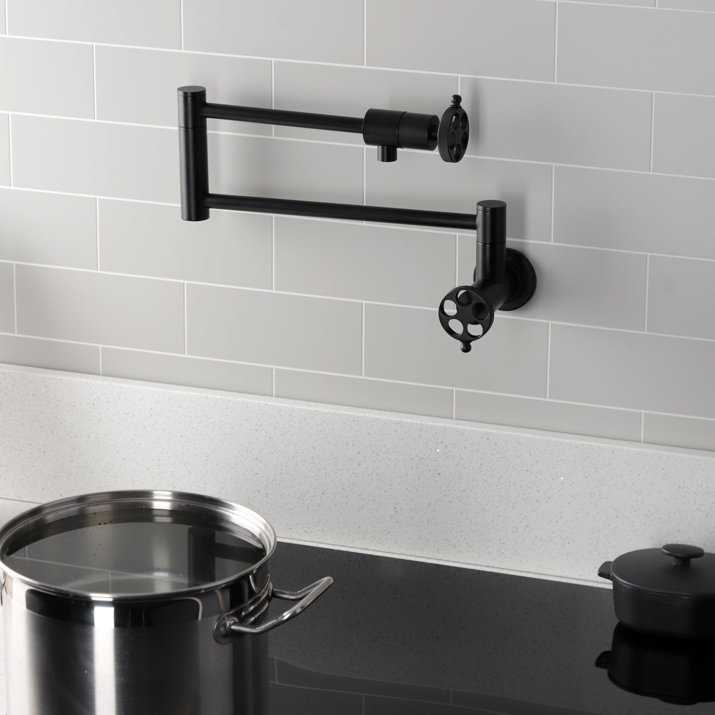 Kingston Brass KS4103RKZ Wendell Wall Mount Pot Filler Faucet with Knurled Handle, Antique Brass in black finish.