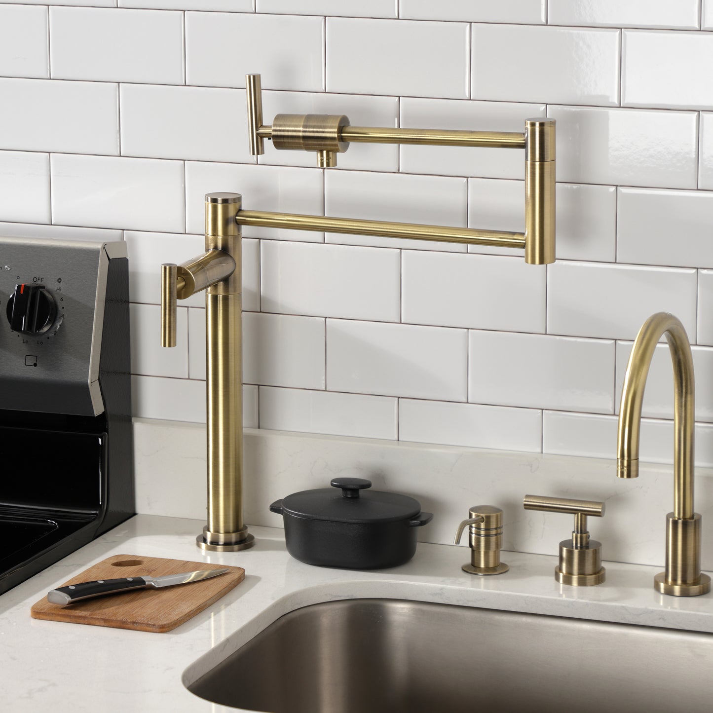 Kingston Brass KS4703CML Manhattan Deck Mount Pot Filler Faucet, Antique Brass installed in a modern kitchen.