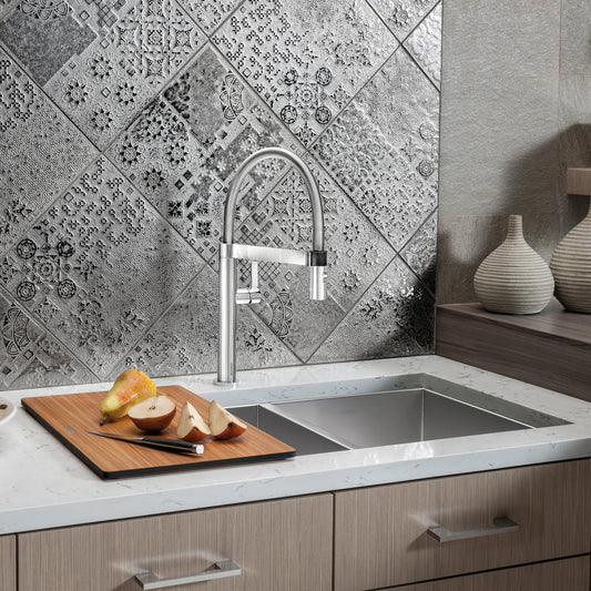 BLANCO Quatrus R0 33" 60/40 Double Bowl Undermount Stainless Kitchen Sink with modern faucet and wooden cutting board.