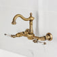 Kingston KS1263WLL Willshire Two-Handle Wall Mount Bridge Kitchen Faucet, Antique Brass design with elegant detailing.