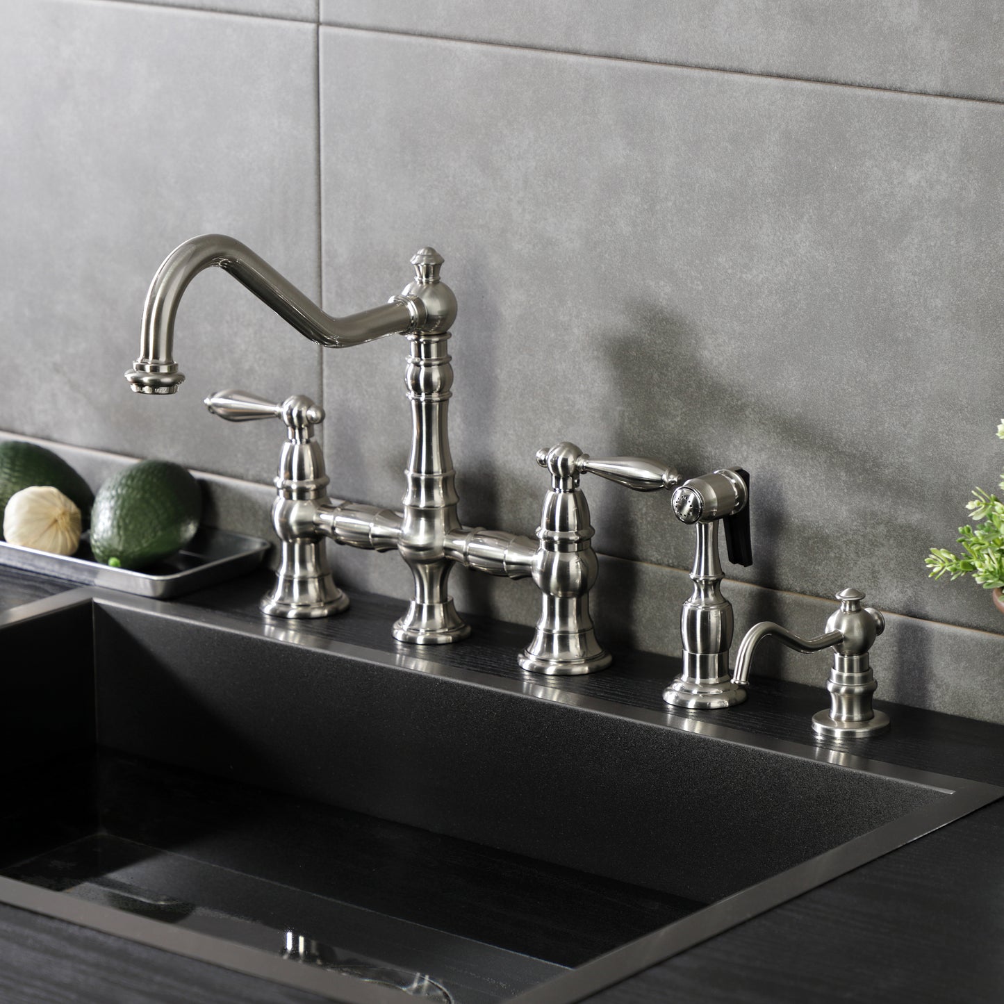 Kingston KS3277ALBS Restoration Bridge Kitchen Faucet with Brass Sprayer, Brushed Brass in a modern kitchen setting.