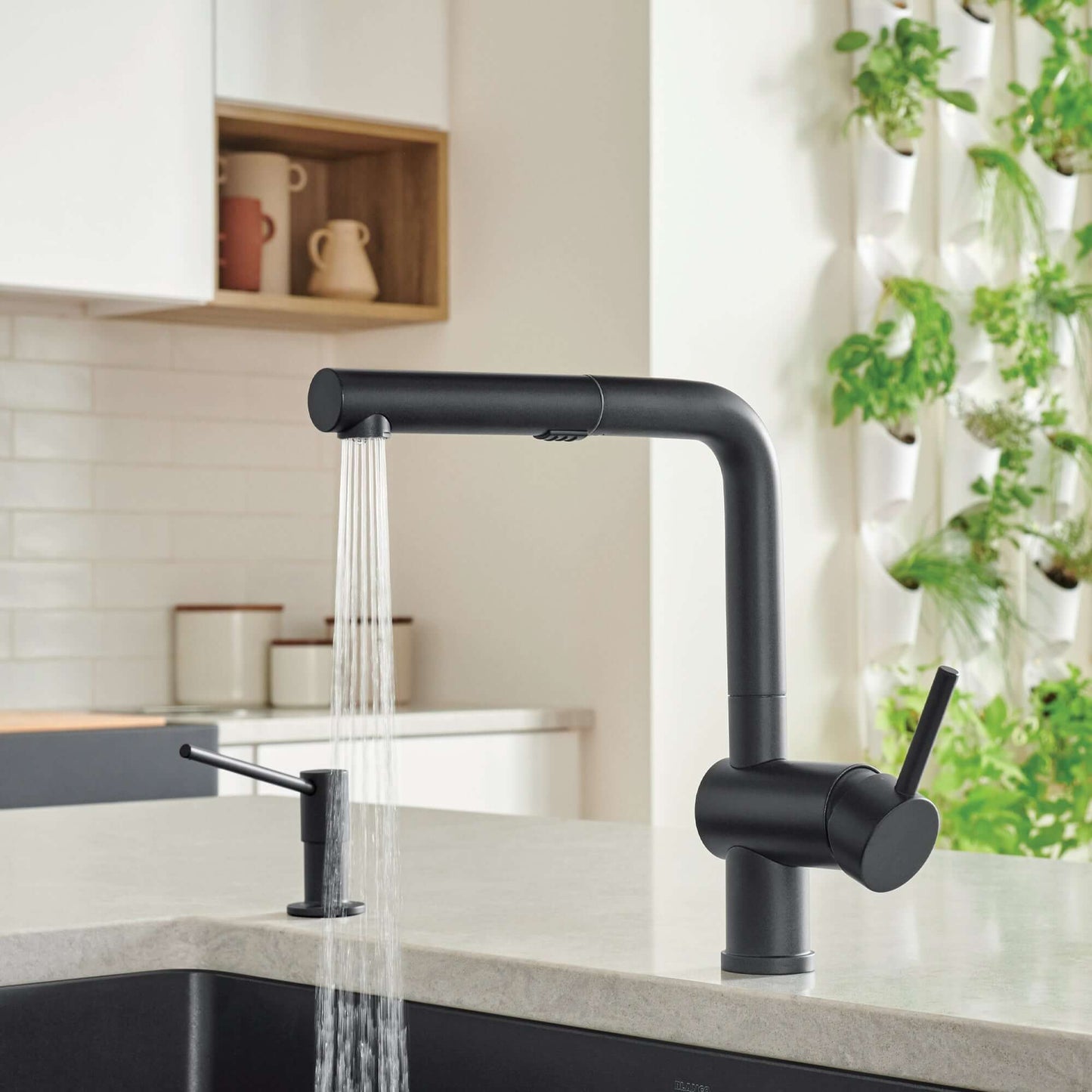 BLANCO Linus Low Arc Pull-Out Dual-Spray Kitchen Faucet - with running water in a modern kitchen setting.