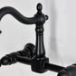 Kingston KS1263AX Heritage Two-Handle Wall Mount Bridge Kitchen Faucet, Antique Brass close-up of handle