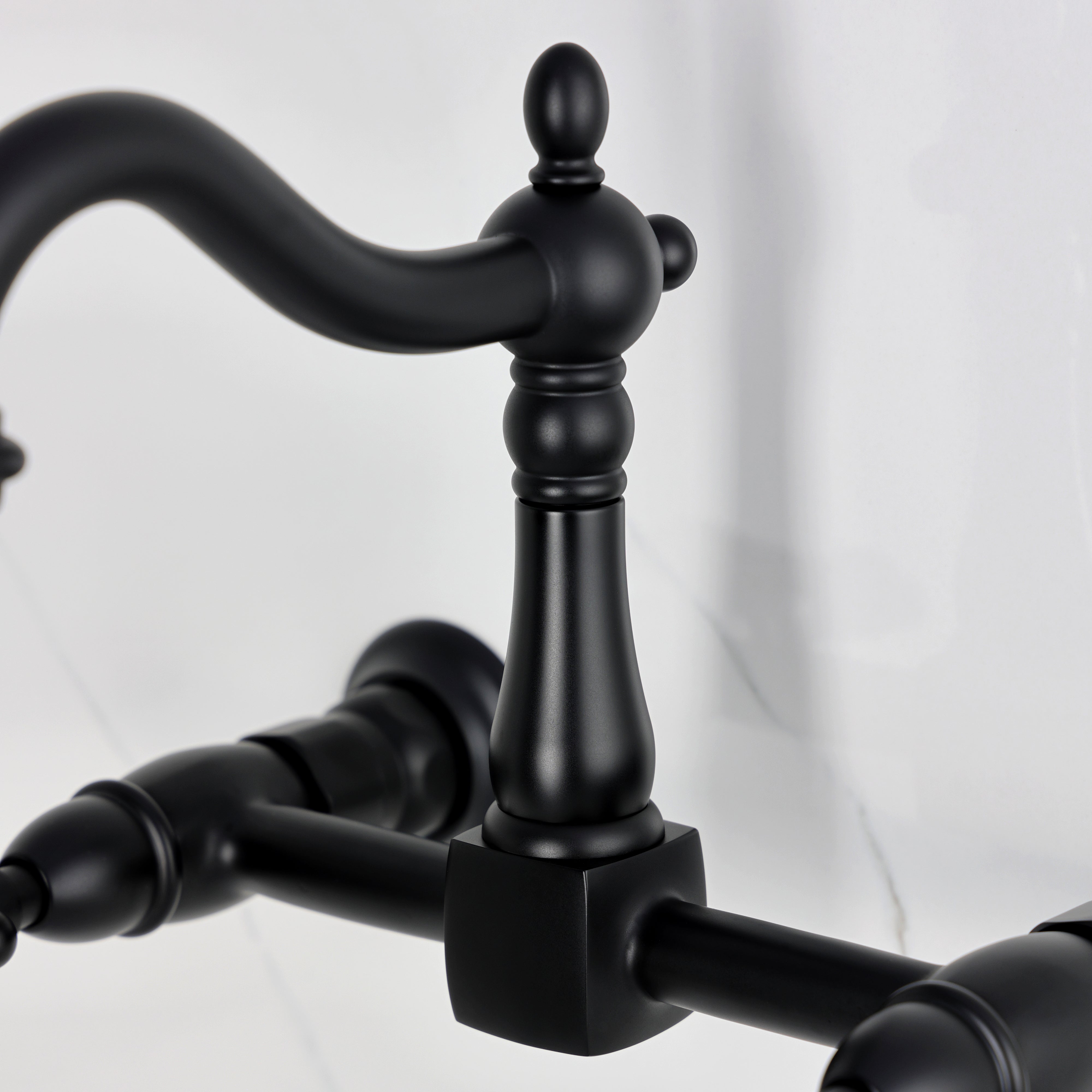 Kingston KS1263AX Heritage Two-Handle Wall Mount Bridge Kitchen Faucet, Antique Brass close-up of handle