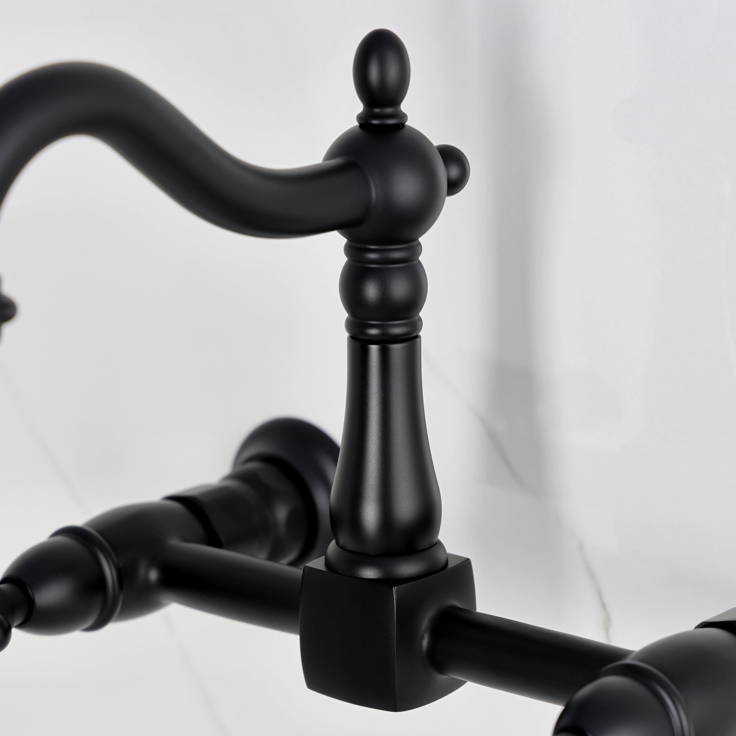 Kingston KS1263AX Heritage Two-Handle Wall Mount Bridge Kitchen Faucet, Antique Brass close-up of handle