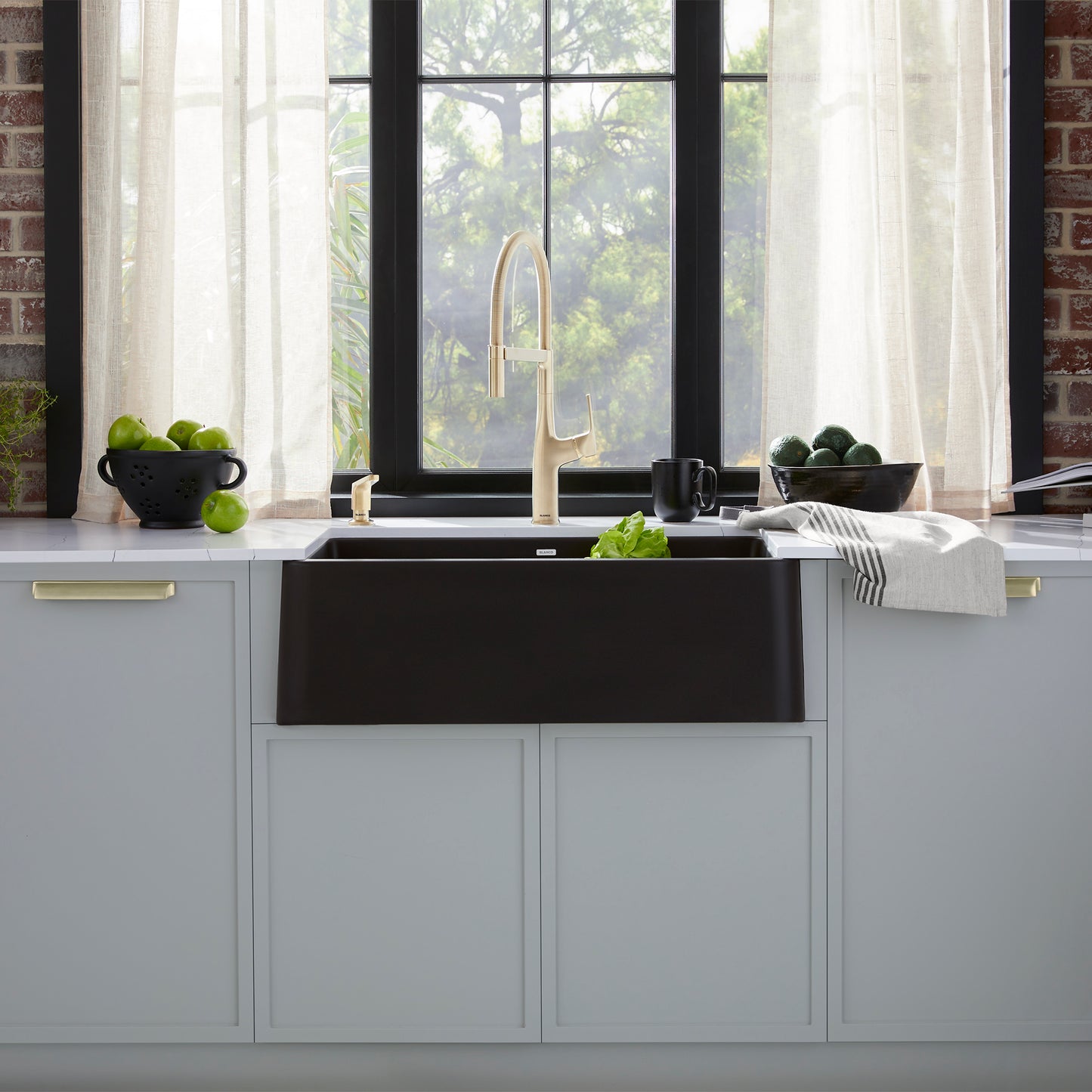 BLANCO Ikon SILGRANIT 30" Single Bowl Apron-Front Farmhouse Sink in a stylish kitchen setting with a window.