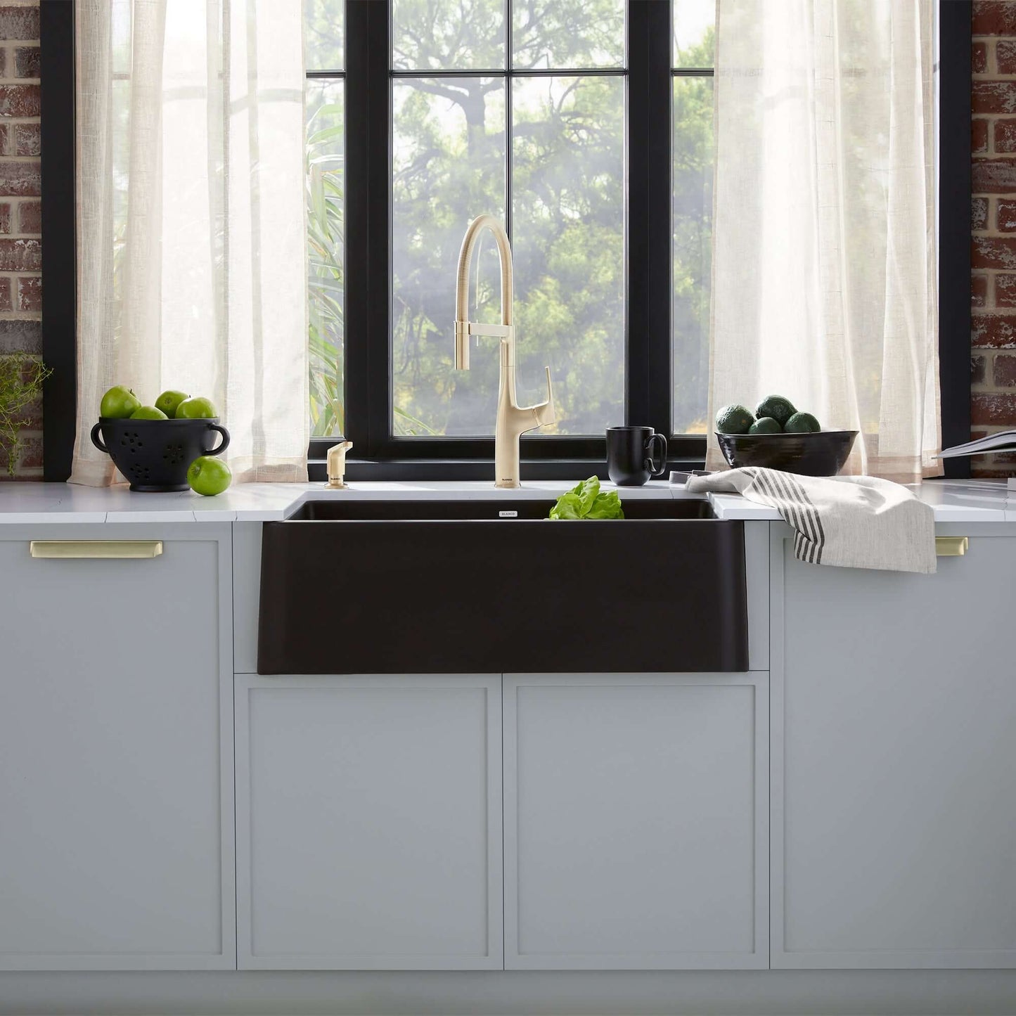 BLANCO Ikon SILGRANIT 33" Single Bowl Apron-Front Farmhouse Sink in a modern kitchen with natural light.