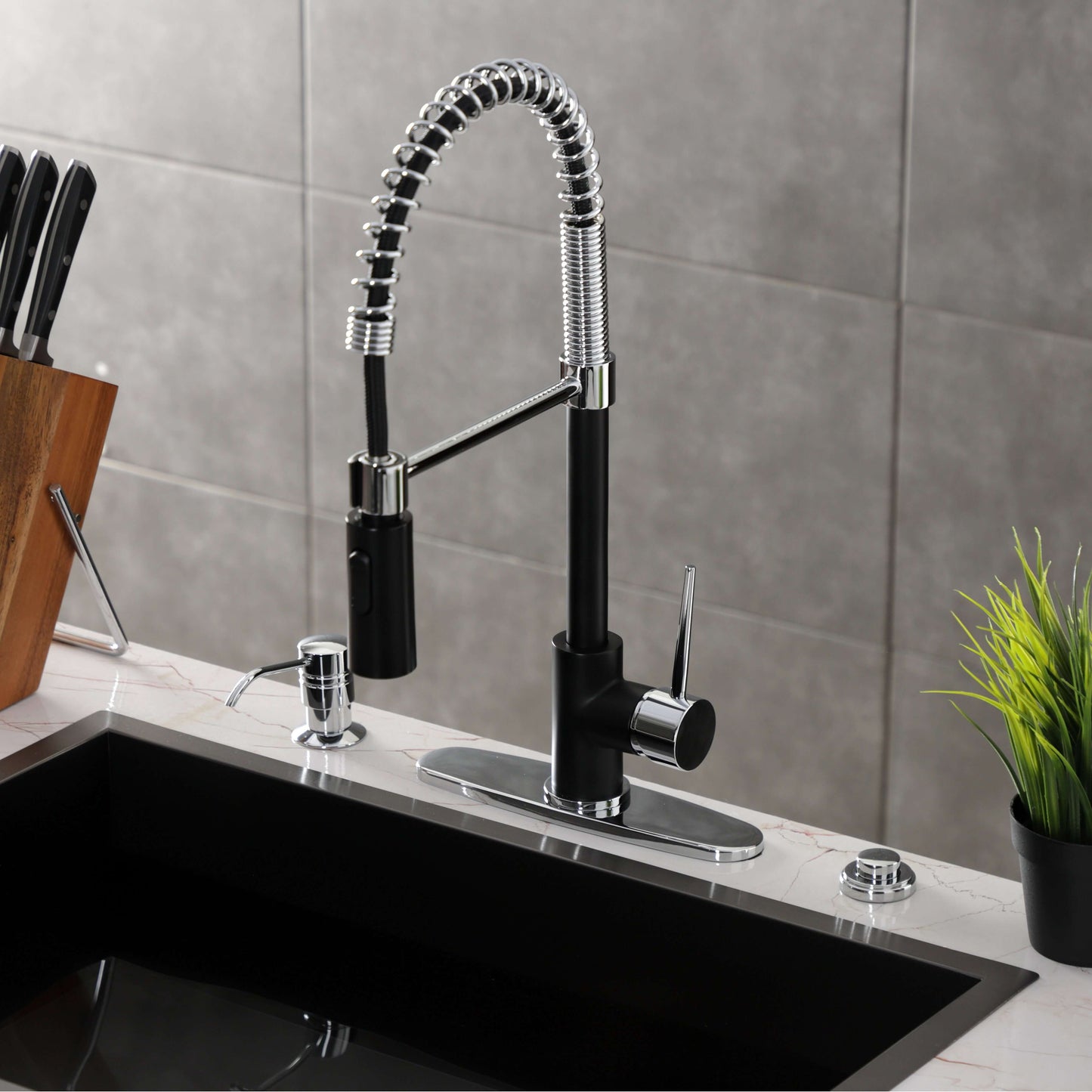 Kingston Brass LS8778NYL New York Pre-Rinse Kitchen Faucet angled view showing sprayer and lever on a modern kitchen sink.