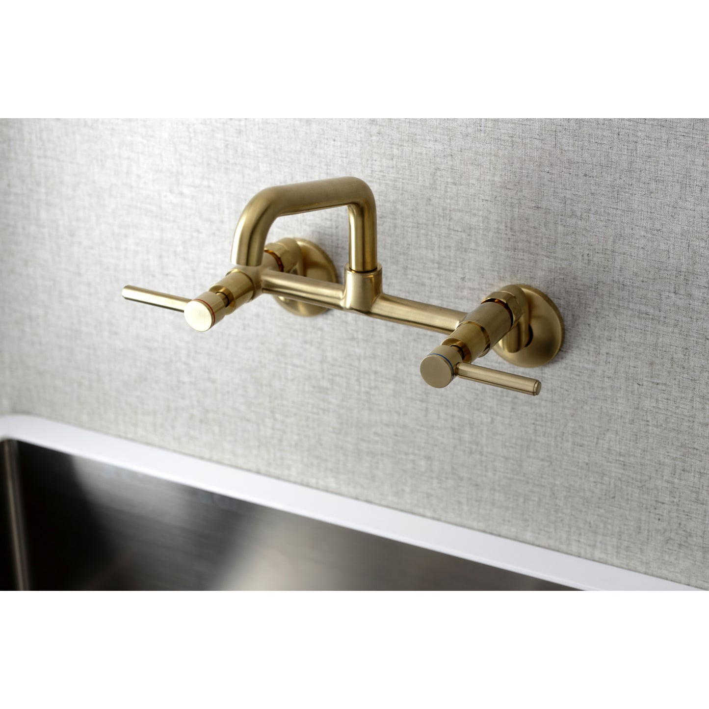 Kingston Brass KS823SB Concord Wall Mount Bridge Kitchen Faucet in brass finish with modern design.