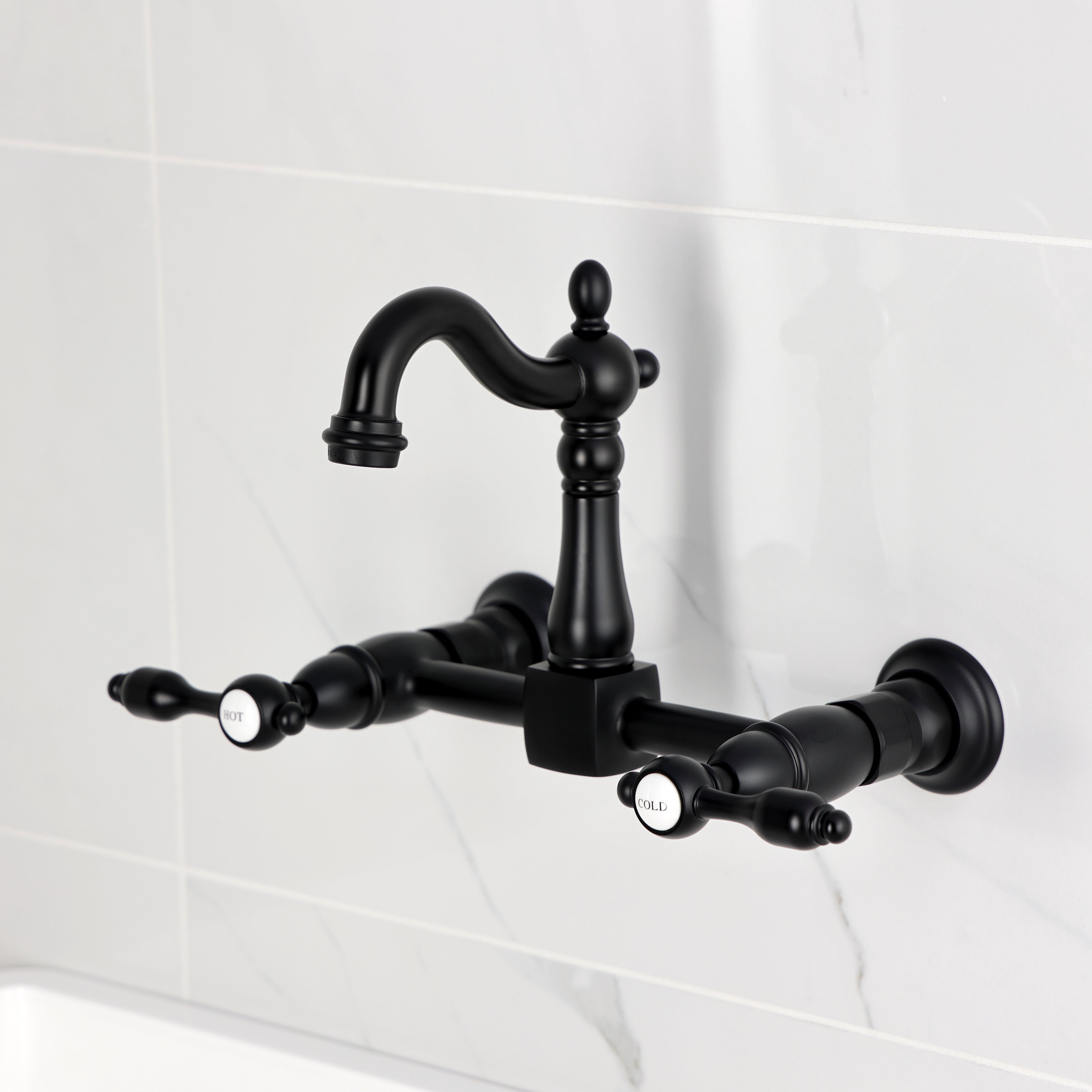 Kingston KS2443TAL Tudor Two-Handle Wall Mount Bridge Kitchen Faucet, Antique Brass with black finish.