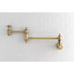 Kingston Brass KS3103AX Restoration Wall Mount Pot Filler Faucet, Antique Brass mounted on white tiled wall.