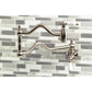 Kingston Brass KS2107PL Heritage Wall Mount Pot Filler Faucet, Brushed Brass on a stylish kitchen backsplash.