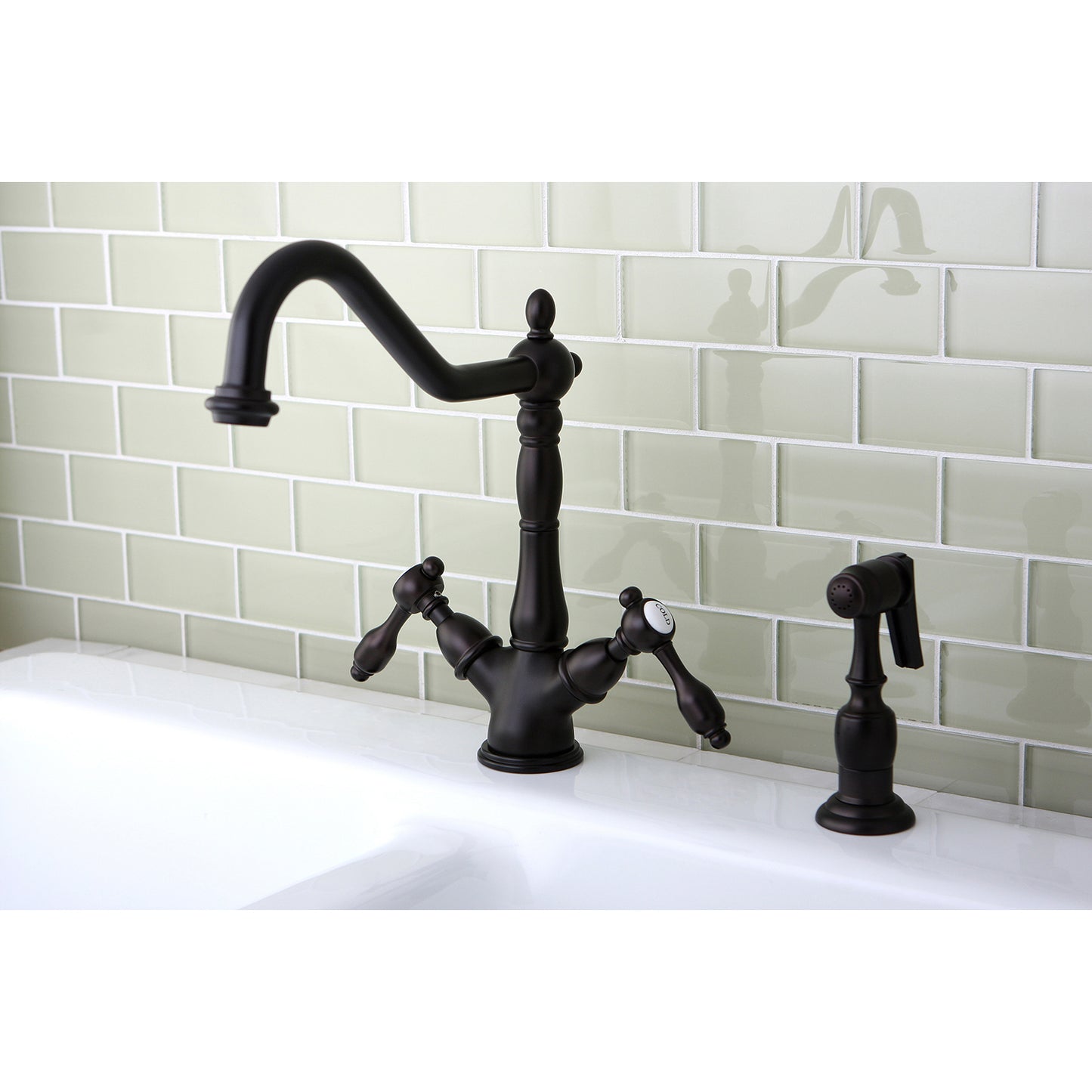 Kingston KS1238TALBS Tudor Two-Handle Kitchen Faucet with Brass Sprayer, Brushed Nickel on sink