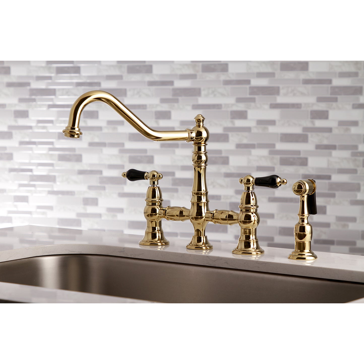 Kingston KS3277PKLBS Duchess Bridge Kitchen Faucet with Brass Sprayer, Brushed Brass on a countertop.