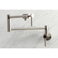 Kingston Brass KS4103DL Concord Wall Mount Pot Filler Faucet, Antique Brass on marble background.