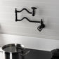 Kingston Brass KS2107RX Belknap Wall Mount Pot Filler Faucet, Brushed Brass in a stylish kitchen setting.