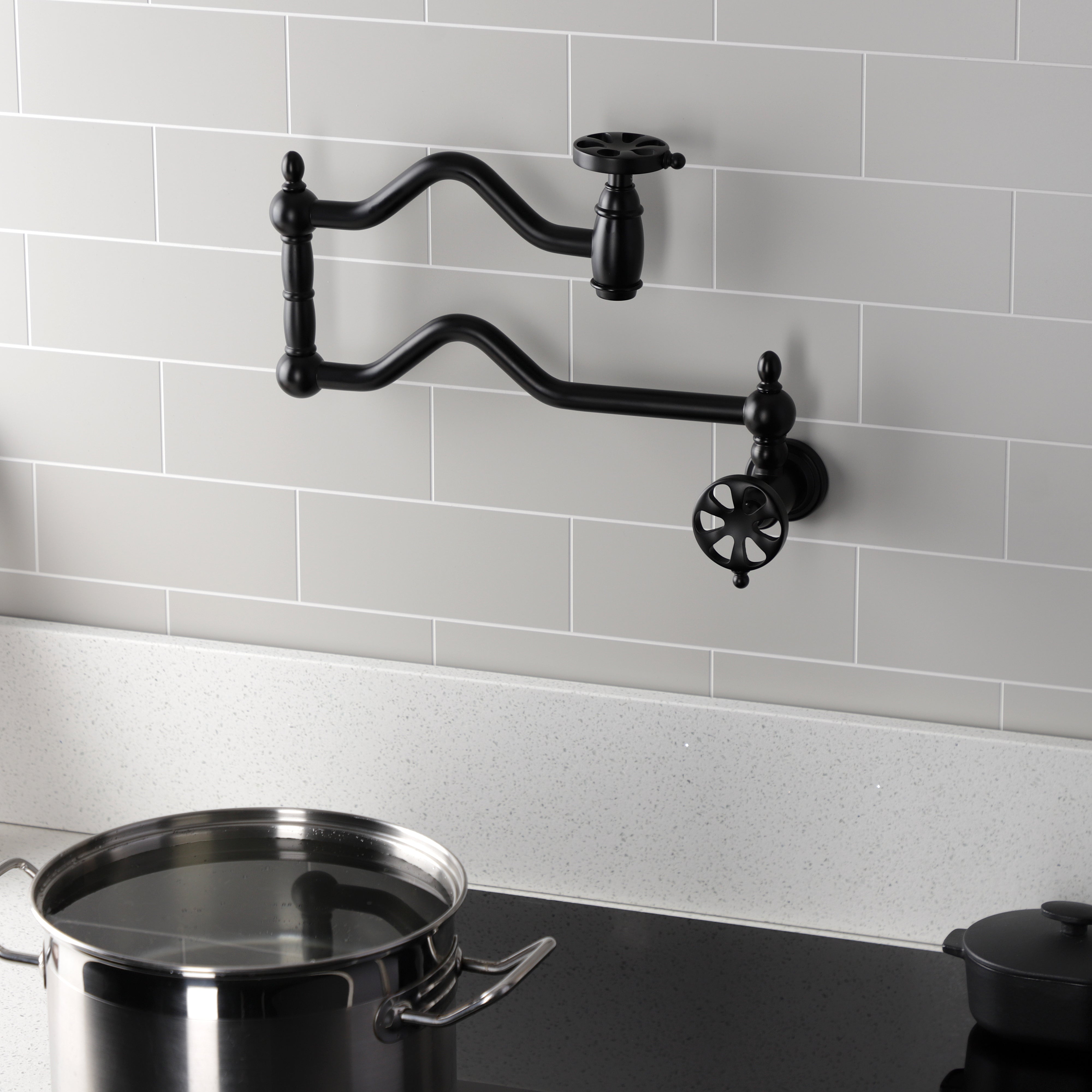 Kingston Brass KS2107RX Belknap Wall Mount Pot Filler Faucet, Brushed Brass in a stylish kitchen setting.