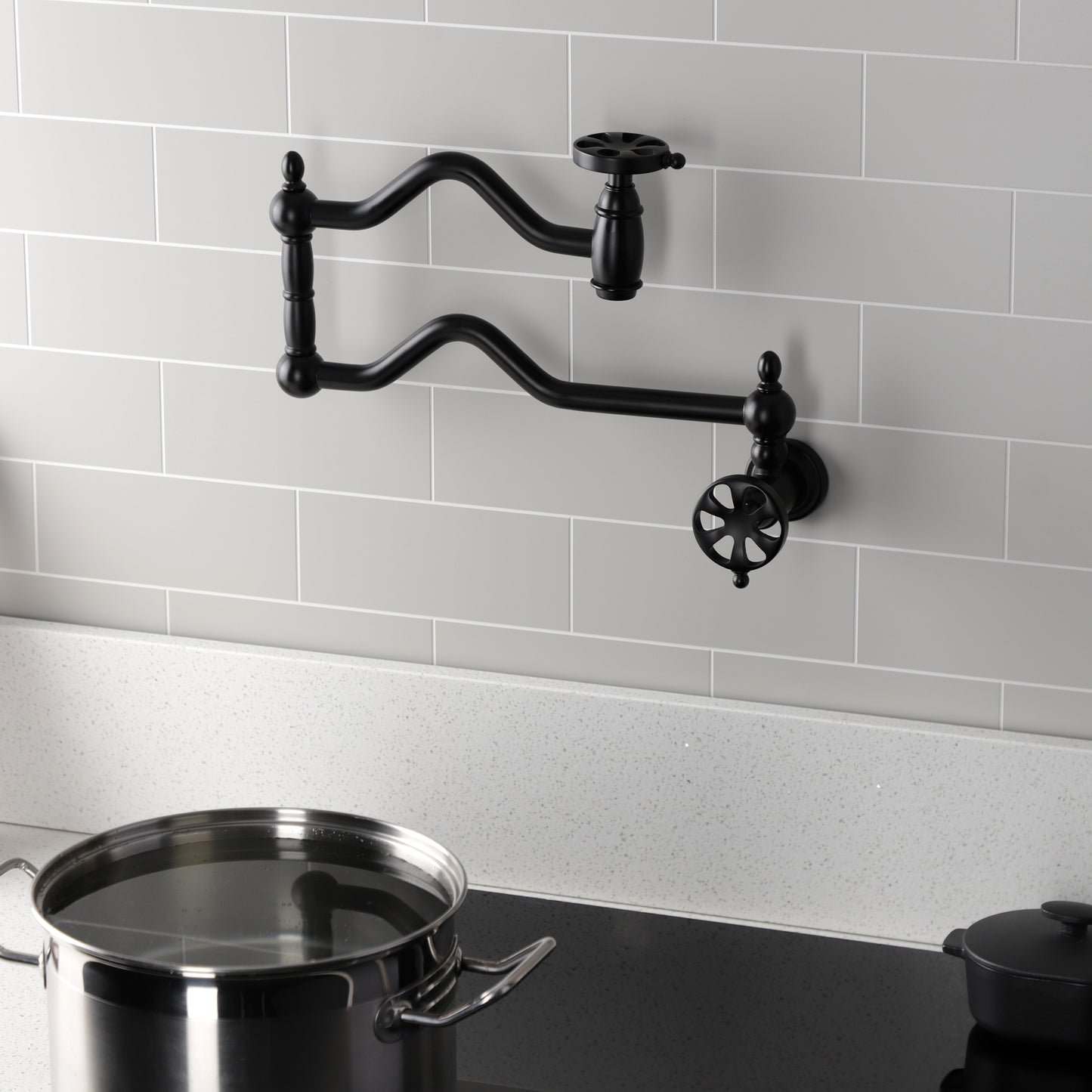 Kingston Brass KS2107RX Belknap Wall Mount Pot Filler Faucet, Brushed Brass in a stylish kitchen setting.