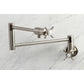Kingston Brass KS4103BEX Essex Wall Mount Pot Filler Faucet, Antique Brass in a stylish design on marble surface.