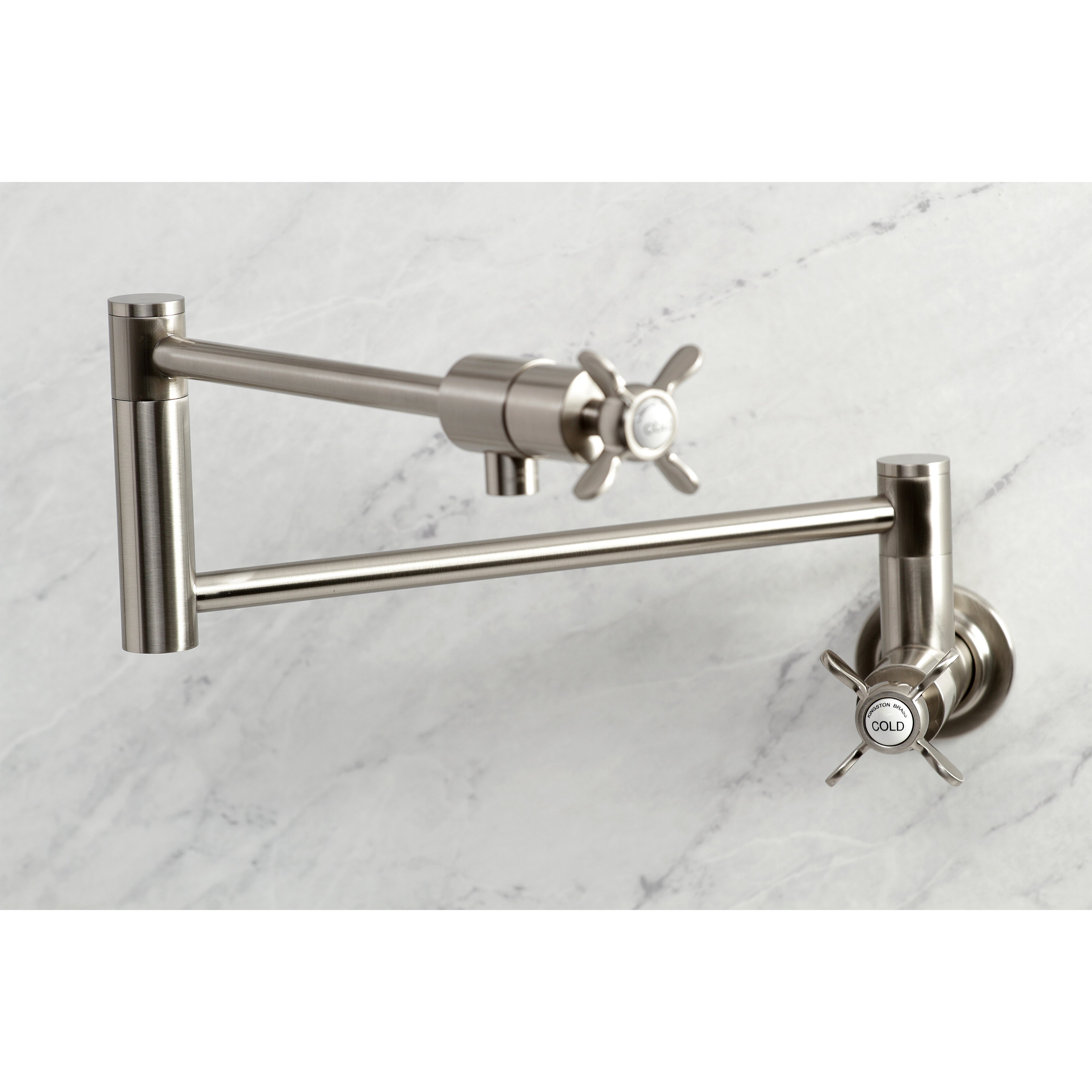 Kingston Brass KS4103BEX Essex Wall Mount Pot Filler Faucet, Antique Brass in a stylish design on marble surface.