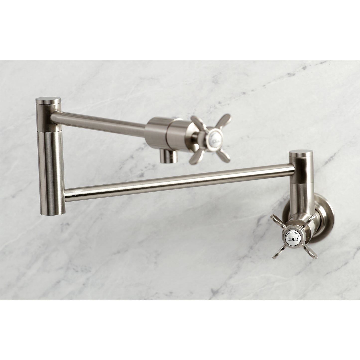 Kingston Brass KS4103BEX Essex Wall Mount Pot Filler Faucet, Antique Brass in a stylish design on marble surface.