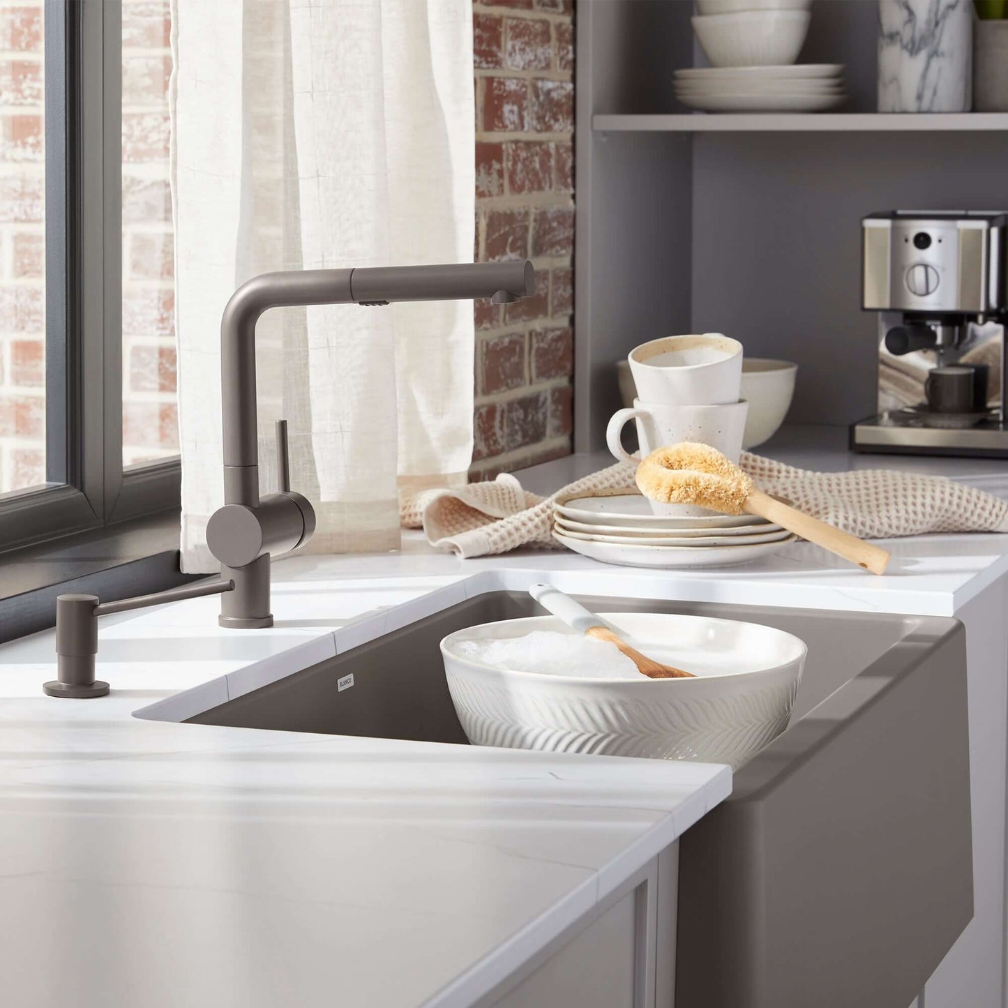 BLANCO Linus Low Arc Pull-Out Dual-Spray Kitchen Faucet - Volcano Gray in modern kitchen setting with dishes.