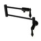 Kingston Brass KS4107PKL Duchess Wall Mount Pot Filler Faucet, Brushed Brass with black porcelain handles.