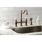 Kingston Brass Heritage Bridge Kitchen Faucet with Brass Sprayer and Cross Handles in oil rubbed bronze finish