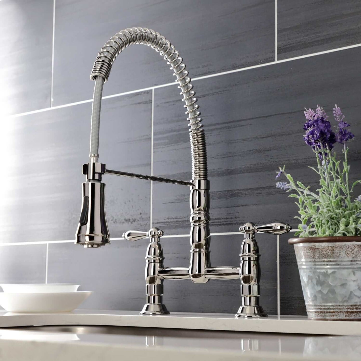 KINGSTON Brass Gourmetier Heritage Two-Handle Kitchen Faucet - Polished Nickel with pull-down sprayer in kitchen setting
