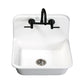 Kingston Brass KS814SB Concord Wall Mount Bridge Kitchen Faucet installed above a white farmhouse sink.