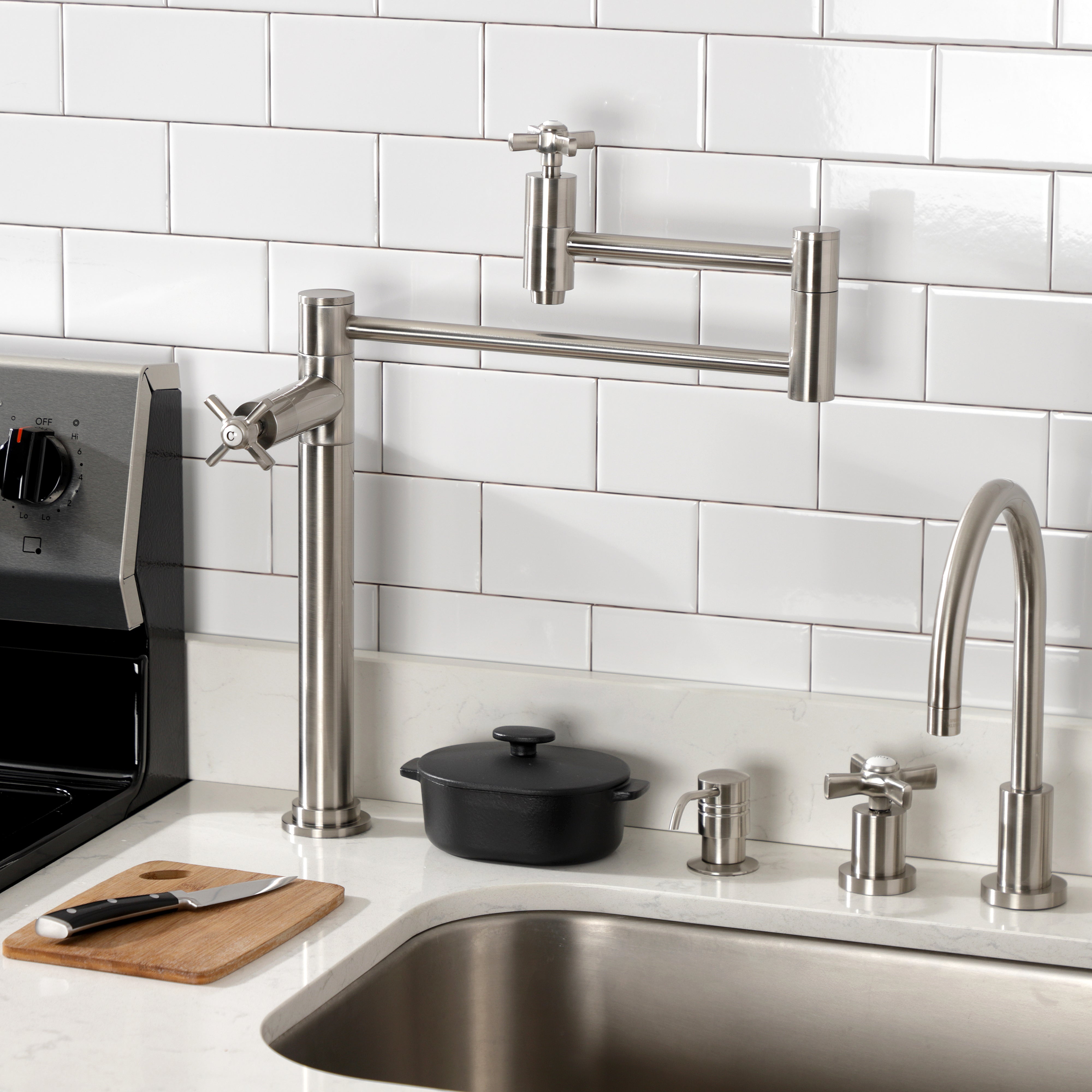 Kingston Brass KS8707ZX Millennium Deck Mount Pot Filler Faucet, Brushed Brass installed in kitchen setting with stove and sink.