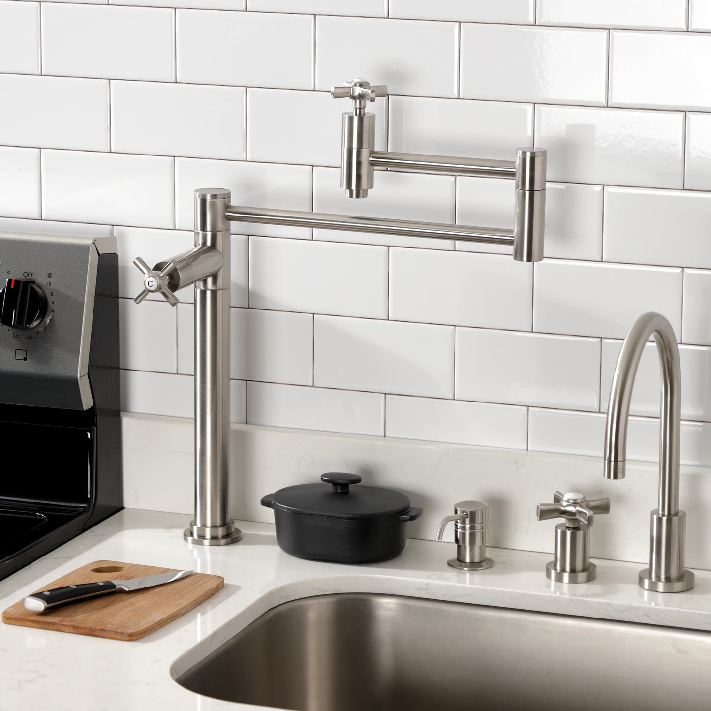 Kingston Brass KS8707ZX Millennium Deck Mount Pot Filler Faucet, Brushed Brass installed in kitchen setting with stove and sink.