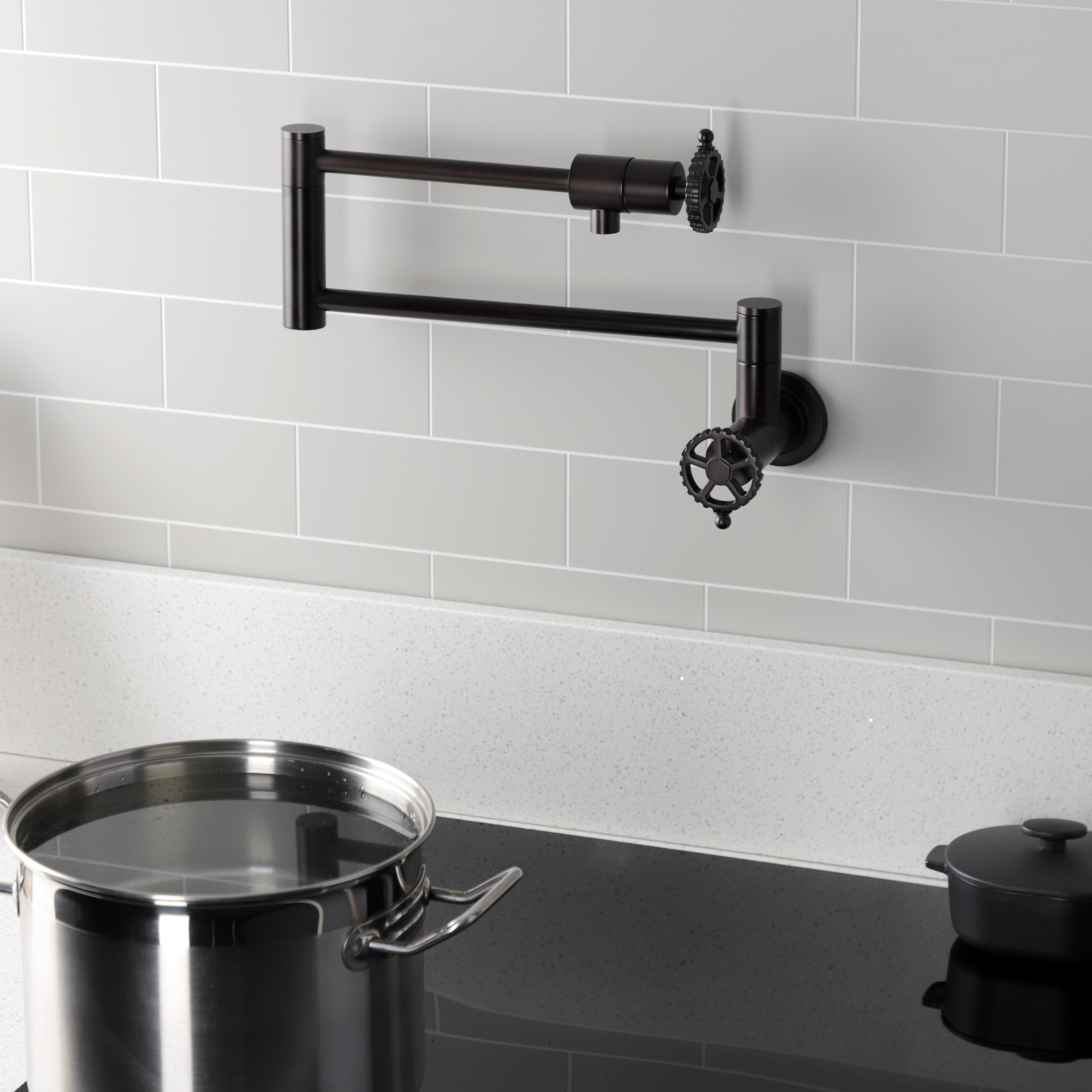 Kingston Brass KS4103CG Fuller Wall Mount Pot Filler Faucet, Antique Brass on kitchen wall with pot.