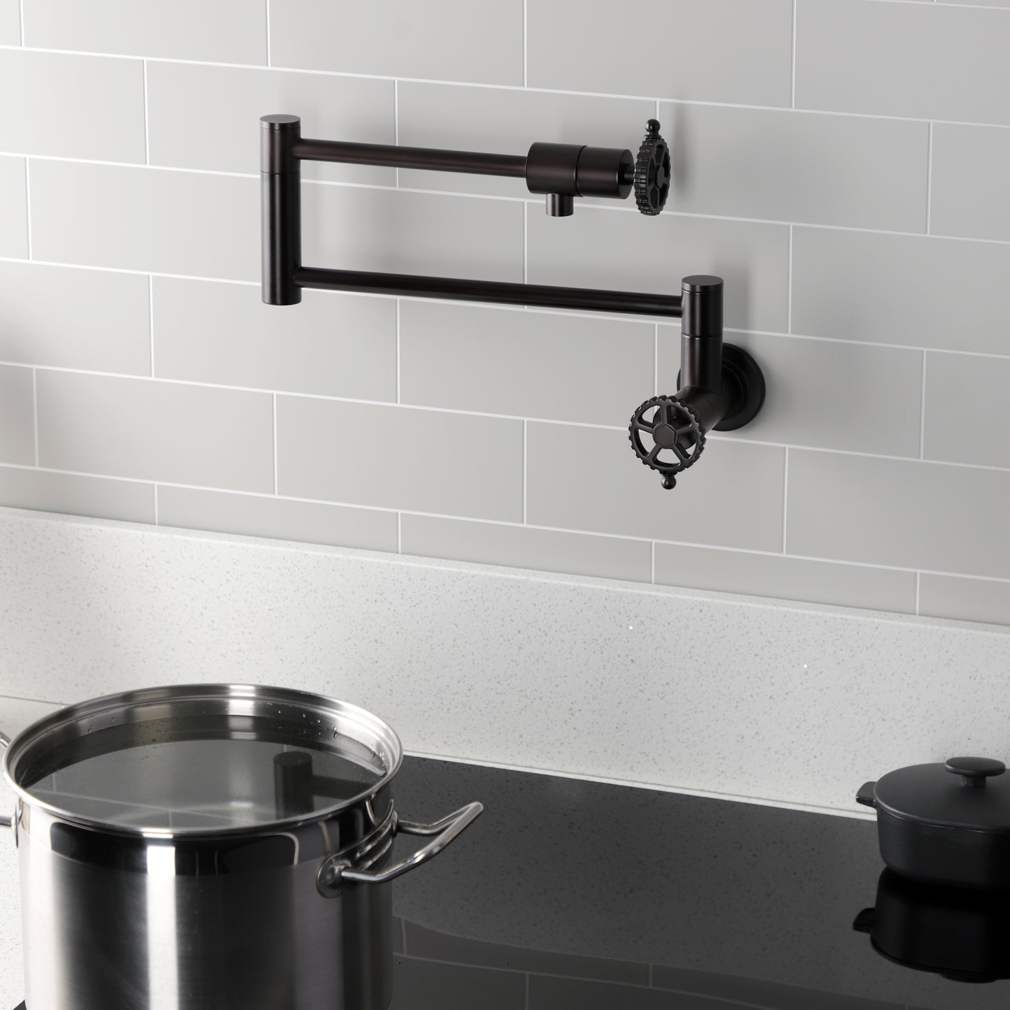 Kingston Brass KS4103CG Fuller Wall Mount Pot Filler Faucet, Antique Brass on kitchen wall with pot.