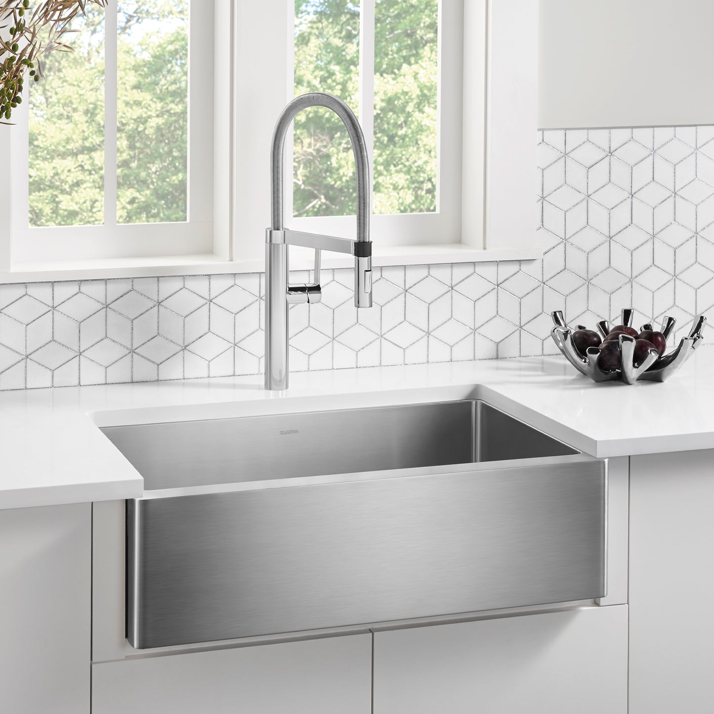 BLANCO Quatrus R15 32" Single Bowl Apron-Front Stainless Steel Farmhouse Sink with modern faucet in bright kitchen.