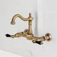 Kingston KS1263PKL Duchess Two-Handle Wall Mount Bridge Kitchen Faucet, Antique Brass on white marble background.